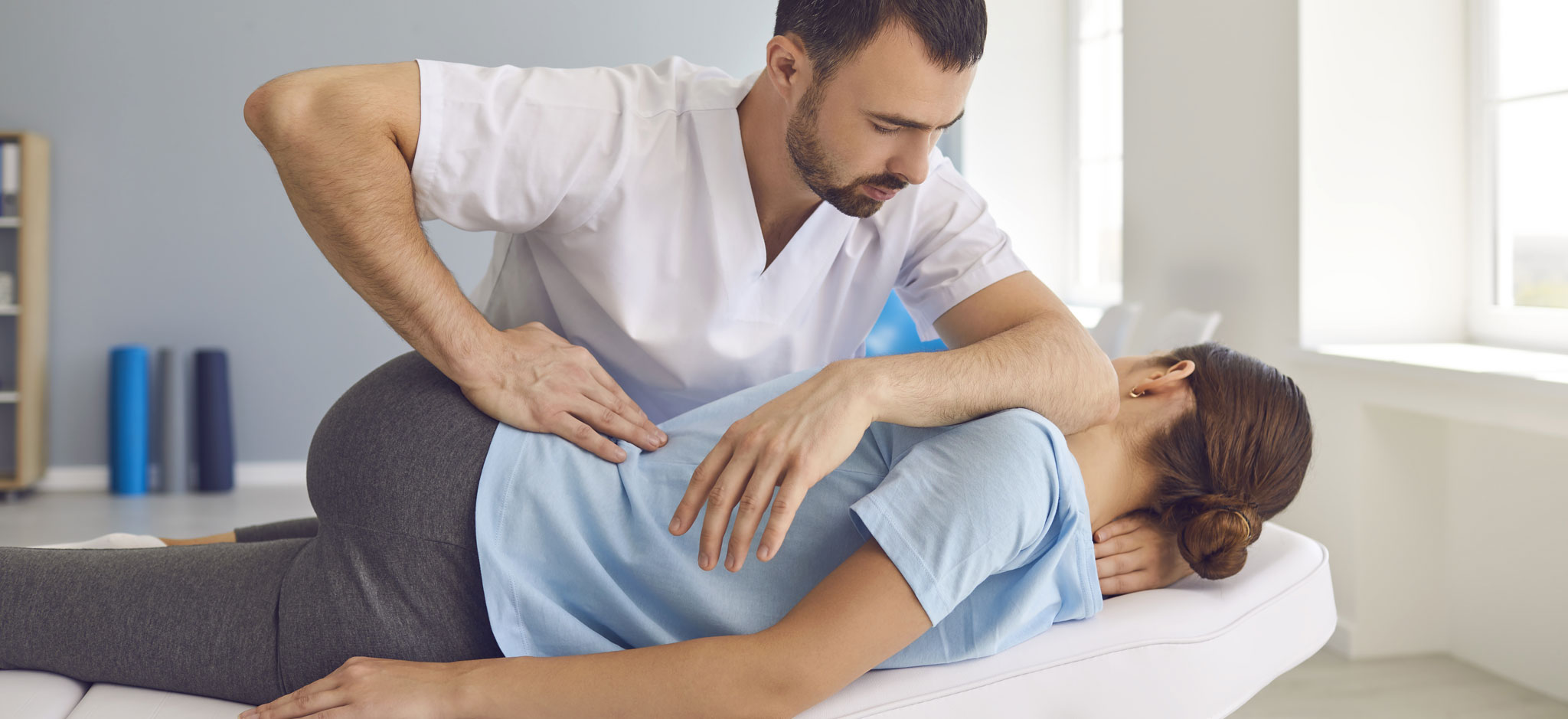 Chiropractor works on a woman's back
