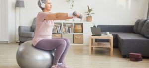 An older woman uses an exercise ball for the GLA:D Program